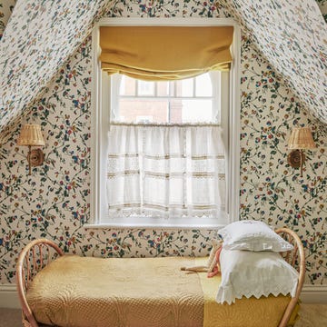 attic bedroom with yellow childrens bed and window with cafe curtain and valance shade