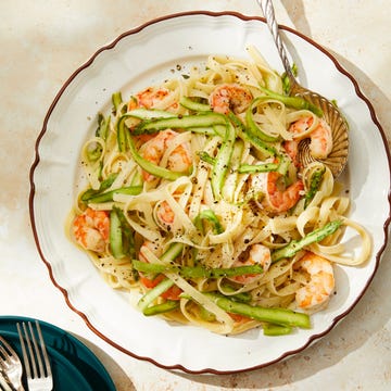 Shrimp fettuccine with asparagus on a plate.