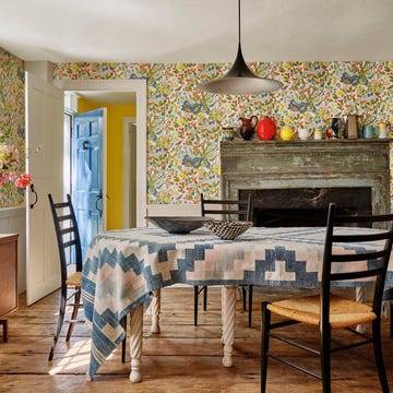 dining room with colorful floral wallpaper and a rug in the dining table